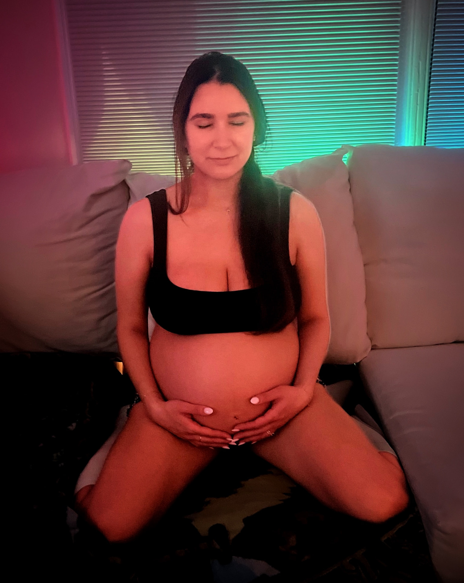 Expectant mother resting peacefully with hands on her belly