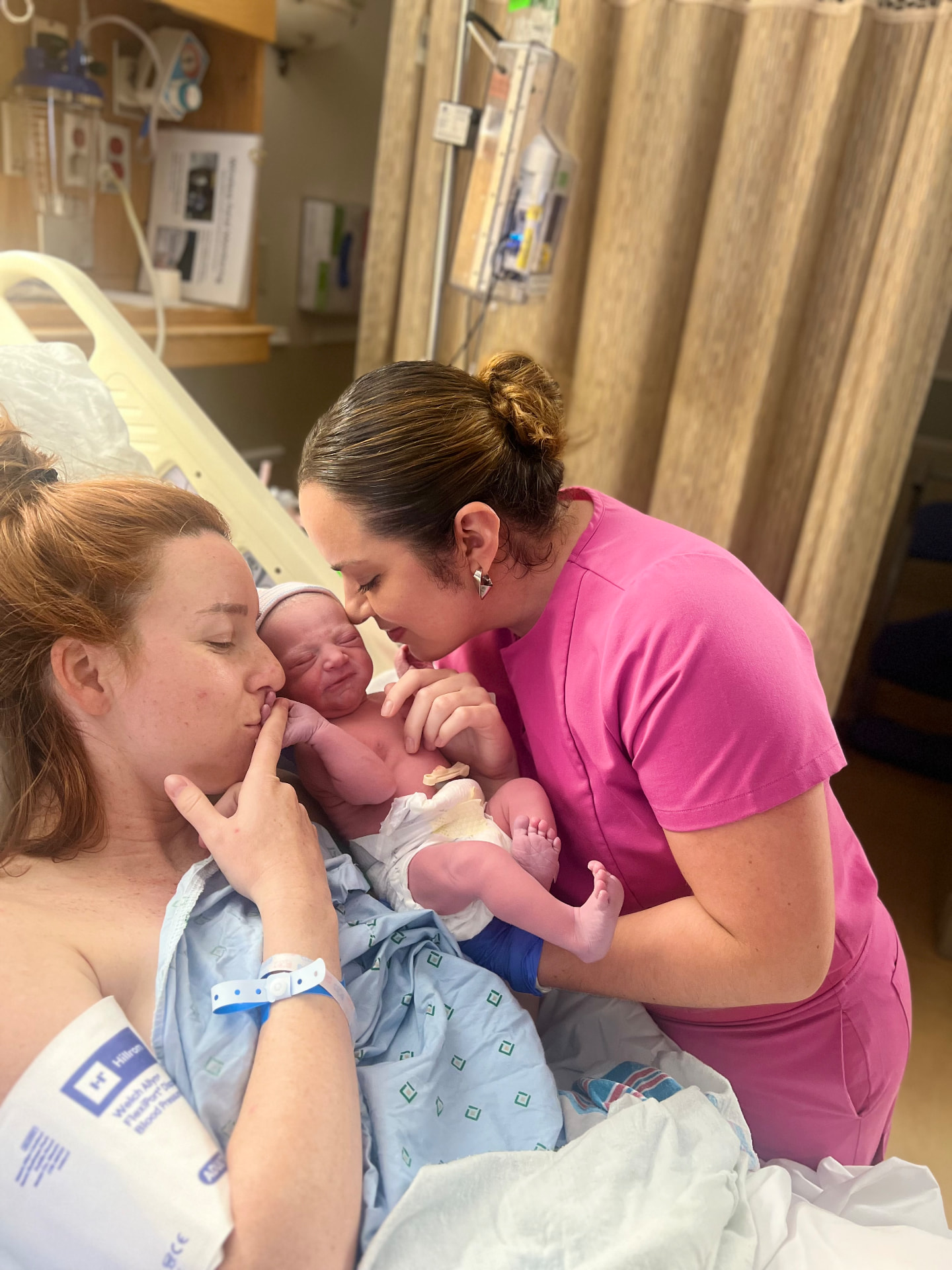 Mother and doula welcoming a newborn