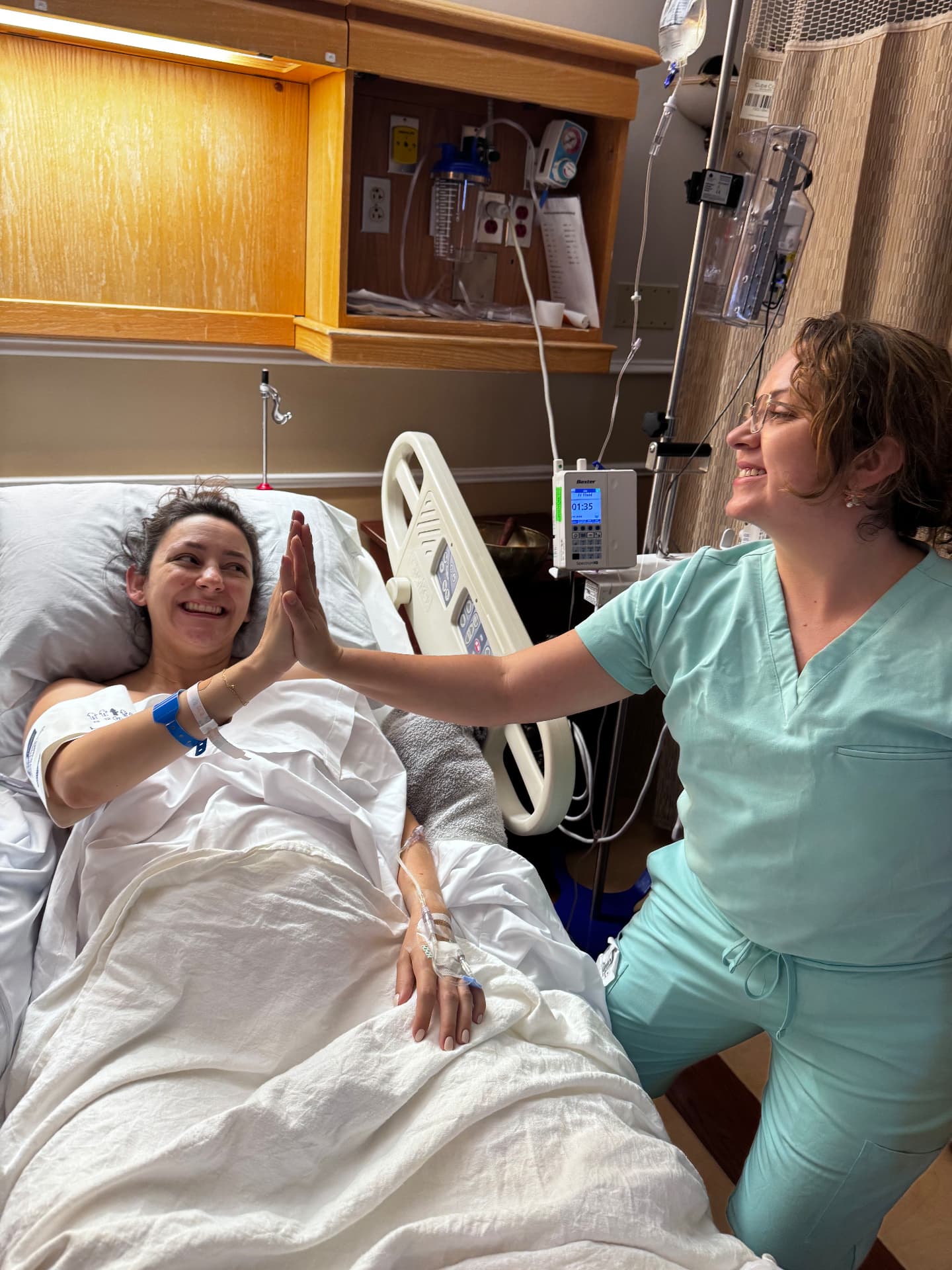 Mother and doula sharing a high five during labor